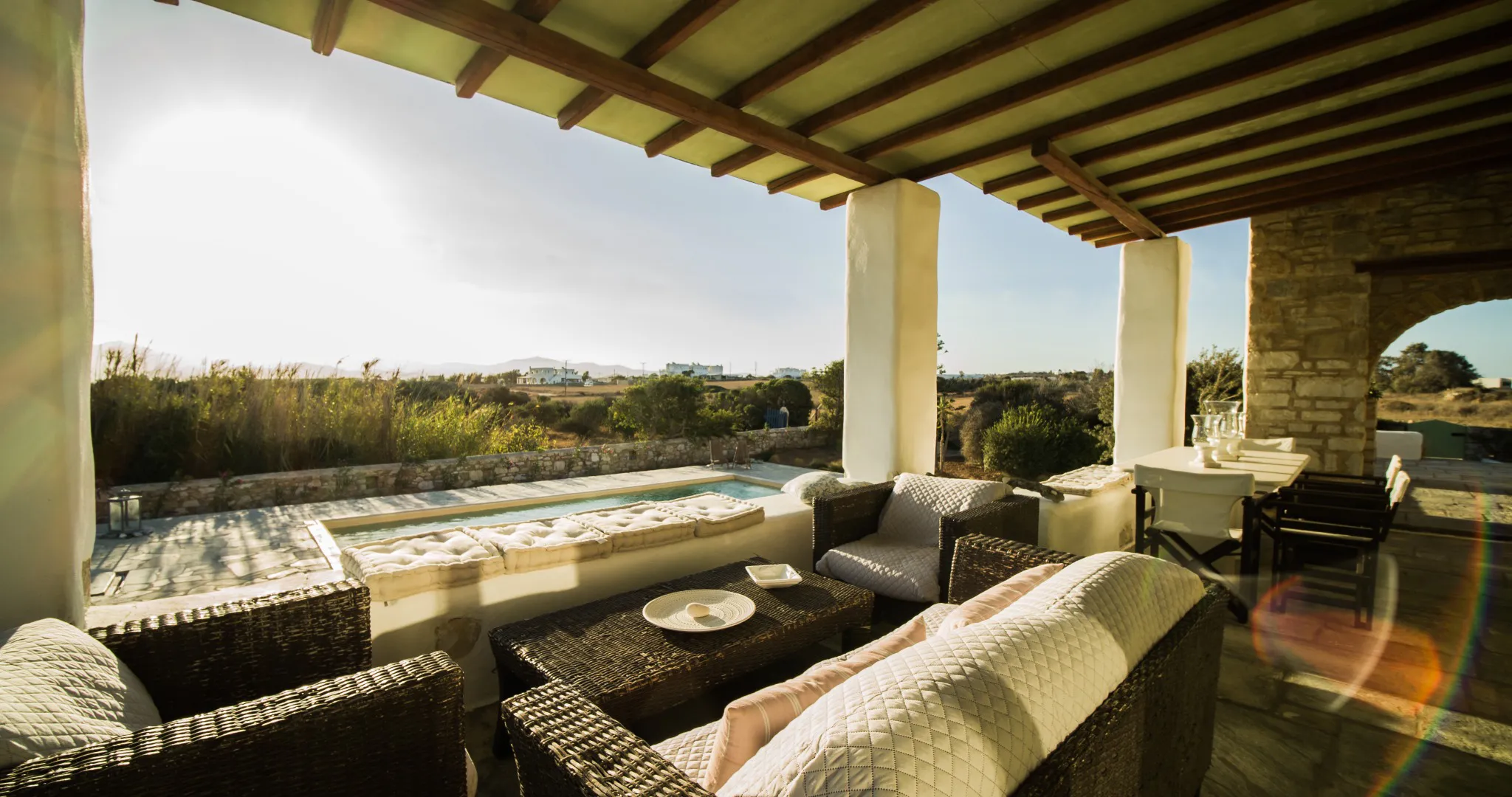 Lithos Private Estate covered outdoor lounge facing the pool
